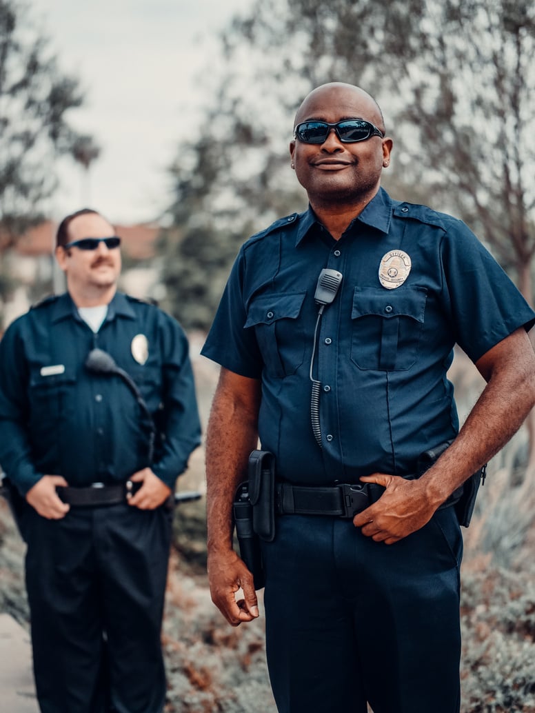 Two Police Officers Wearing Black Sunglasses 